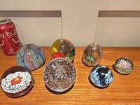 Group shot of all seven paperweights for scale and variety