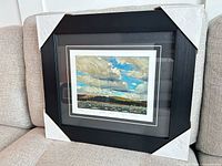 Framed print on sofa showing full frame with protective corners