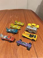 All eight cars grouped on tabletop showing variety