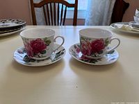 Both jumbo cups on their saucers showcasing pattern and condition