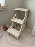 front view of three-step white library stairs