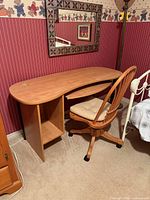 overall view of curved desk and swivel chair against wall