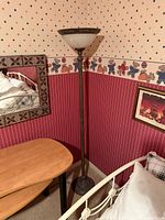 Full view of torchiere floor lamp with glass shade