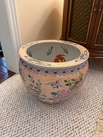 Front view showing exterior floral and bird design