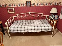 Front view of metal daybed with mattress