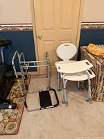 Group view of walker, bed rail, two shower chairs