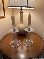 Both crystal candlesticks on table front view