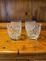 Four Waterford crystal old fashioned glasses angled view