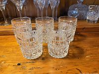 Front view of five Bohemia Crystal whiskey tumblers displaying cut pattern