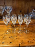 Front view of eight Atlantis Chartres cordial glasses on wooden surface