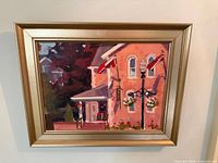 Front view of framed painting depicting pub building with flags