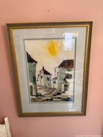 Full view of framed mixed media painting on wall