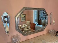 Front view of octagonal silver double border mirror on wall