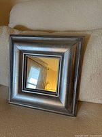 Front view of silver square mirror showing frame and glass