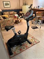 Full side view of Sole B54 upright bike showing frame, seat, pedals and base