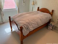 Full view of assembled solid wood twin bed with mattress