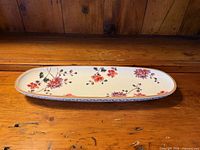 Top view of entire elongated oval fish plate displaying floral pattern