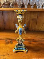 Front view of Italian Majolica griffin-form candlestick