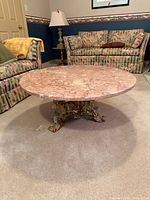 overhead view of round pink marble coffee table on carpet