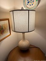 Lamp lit on table showing full shape and shade