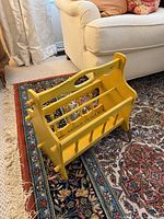 Front view of yellow wood magazine rack