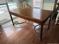 Front view of desk showing drawers, legs and stretcher