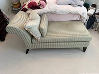 Side view of striped chaise with pillows