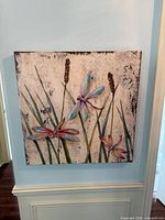 Front view of square dragonfly wall art on wall