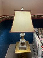 Full view of lamp showing shade, base and finial
