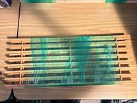 Bundle of two natural pine slatted shelf panels shrink-wrapped together