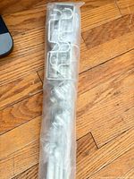 Entire sealed curtain rod set showing finials and brackets