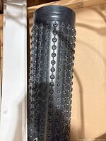 Full view of rolled black dimple membrane standing upright