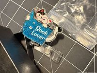 Front view showing glitter cat and book design and clear strap clip