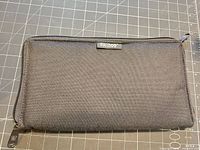 Front view of closed Bulldog black nylon handgun case on cutting mat showing size and texture