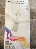 Front of box showing model FC03-50-3, 17-inch size, 110 V rating, image of fan with three blades