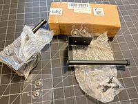 Full contents: two black metal brackets, screws, wall anchors, wall plate, box