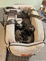 Top view showing interior, removable cushion and bundled safety straps