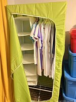 Wardrobe open showing hanging rod, shirts (not included), six-cubby organizer, wire shelf