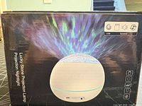 Front of box showing Lucky Stone Projection Lamp graphics and features