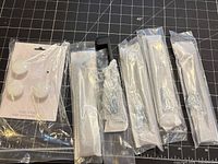 All eight knobs in packaging with screws