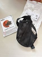 Overall view of dog muzzle with user guide and packaging