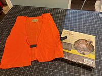 Vest displayed flat next to unopened decoy box