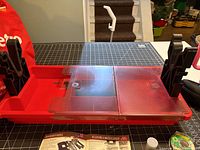 Overall view of red maintenance center with black padded forks and clear lids open