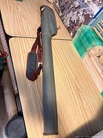 Plano Guide Series hard-shell rod case with shoulder strap on table