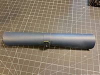 Rolled dark blue PVC vinyl sheet secured with strap on cutting mat