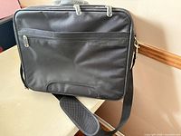 Rear view showing full-width zipper pocket, shoulder strap attached