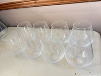 Group of eight standard glasses arranged on table