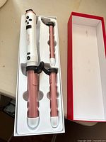 Handle and two rose gold barrels in original tray packaging