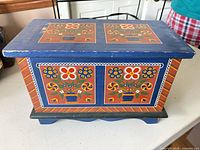 Front and lid showing folk floral painting, overall box form