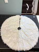 Front of round white faux fur tree skirt showing pile texture and center slit